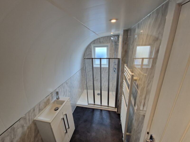 Ensuite bathroom with shower and toilet, fully clad, inside eLodge Max garden lodge