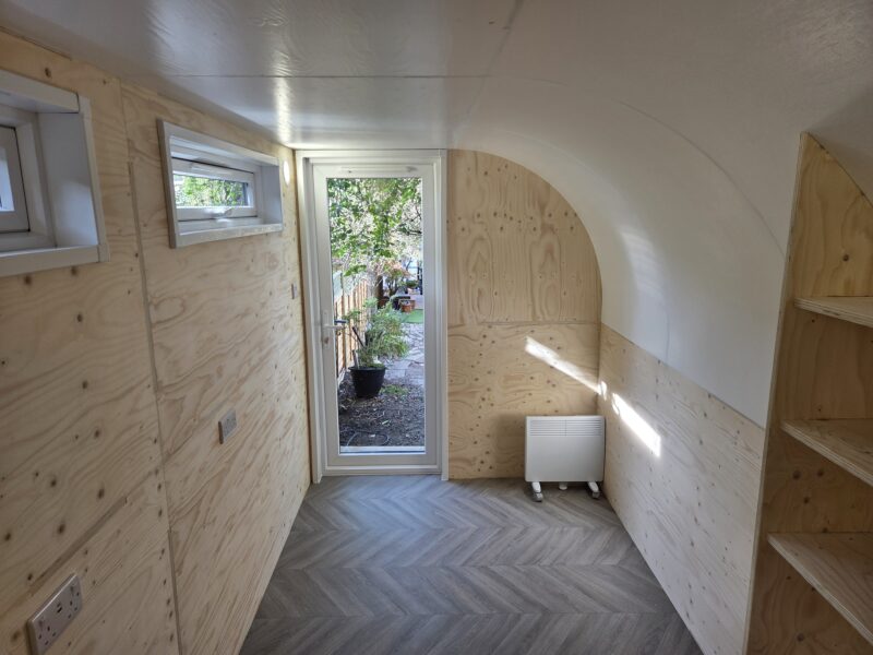 eSnug Plus garden office interior with custom bookshelf and full electrical fit-out