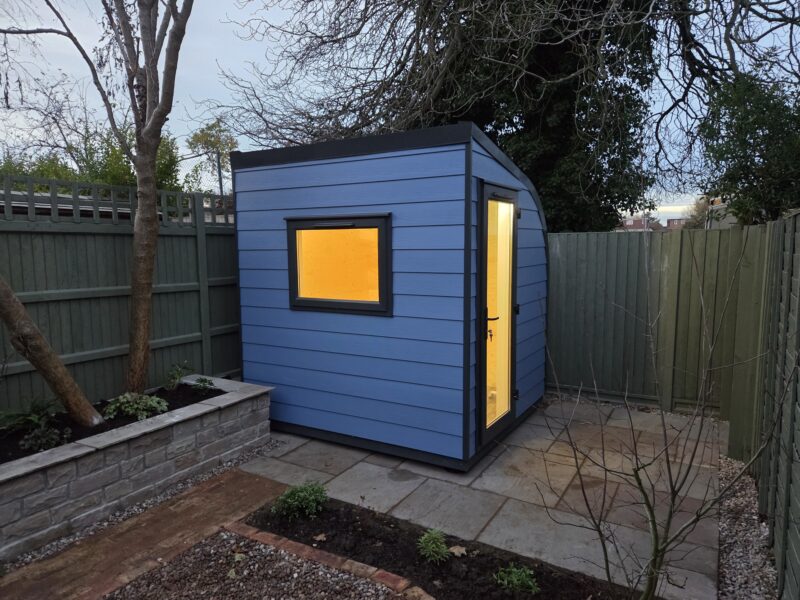 eSnug garden office with east-north side door and pigeon blue cladding