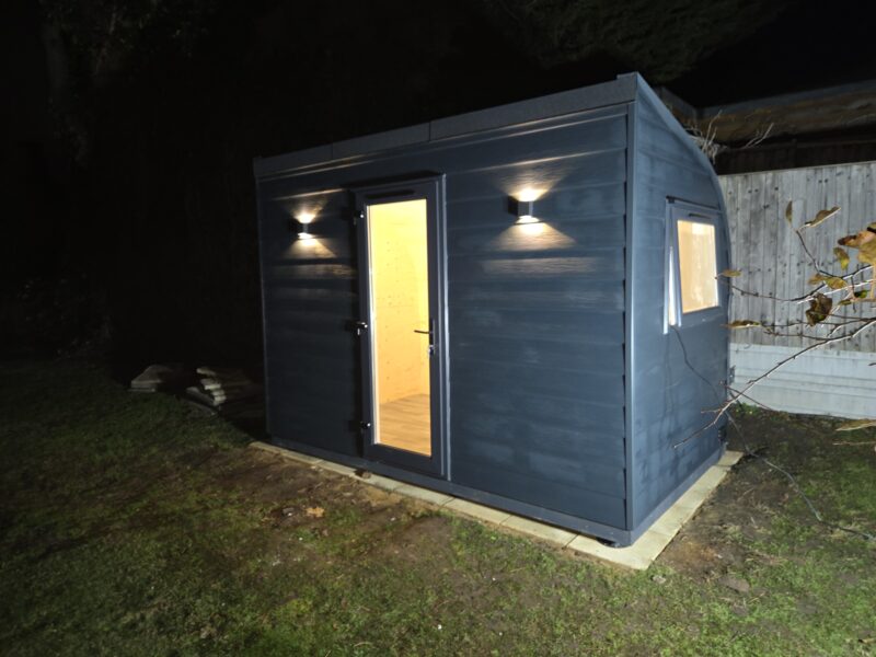eSnug Plus garden studio with Eastern cladding and exterior feature lights