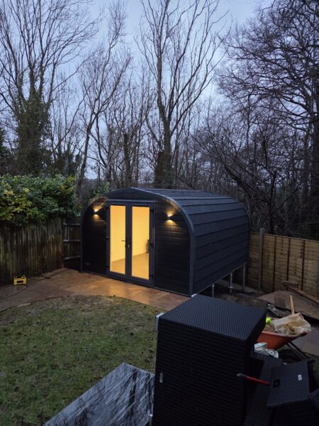 eLodge Max garden lodge exterior illuminated by night-time feature lights